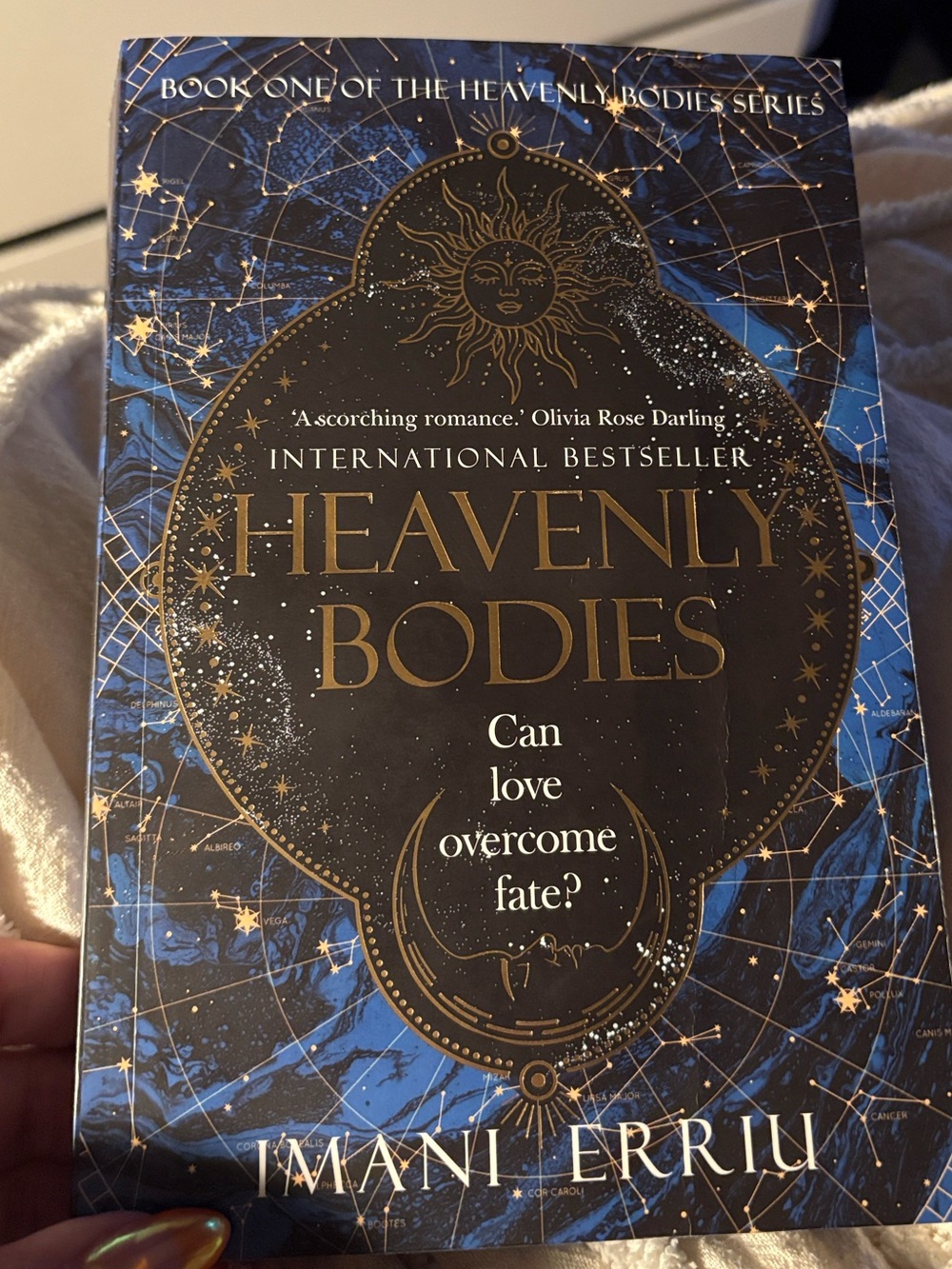 Heavenly Bodies by Imani Erriu — Blue & Gold Paperback Novel